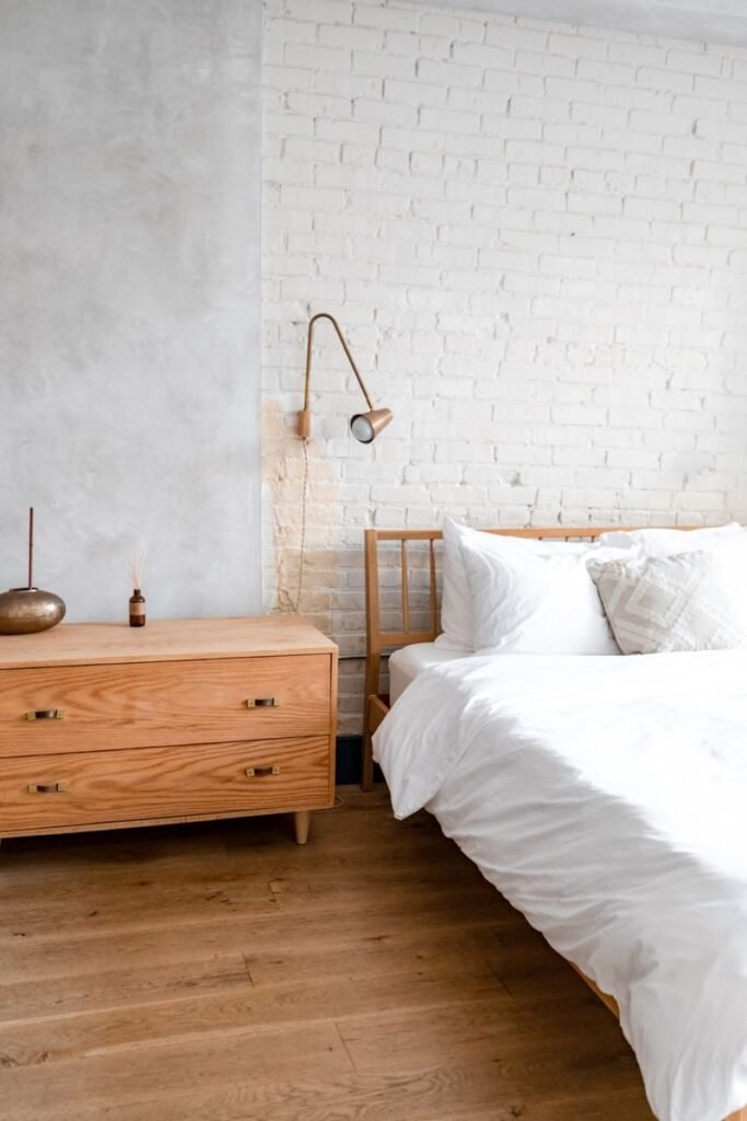 Neutral linen bedding with white pillows on a made bed